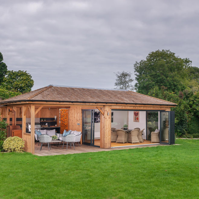 A modern garden office with covered terrace and outdoor workspace