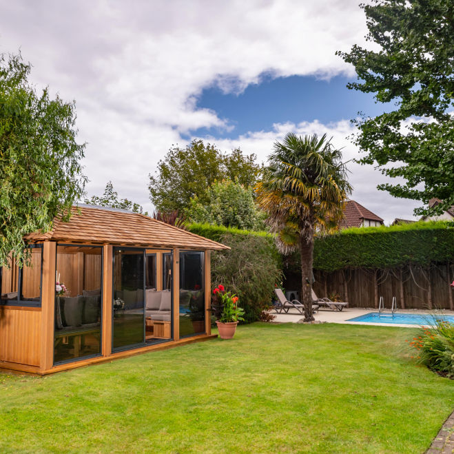 A modern luxury garden room beside a swimming pool
